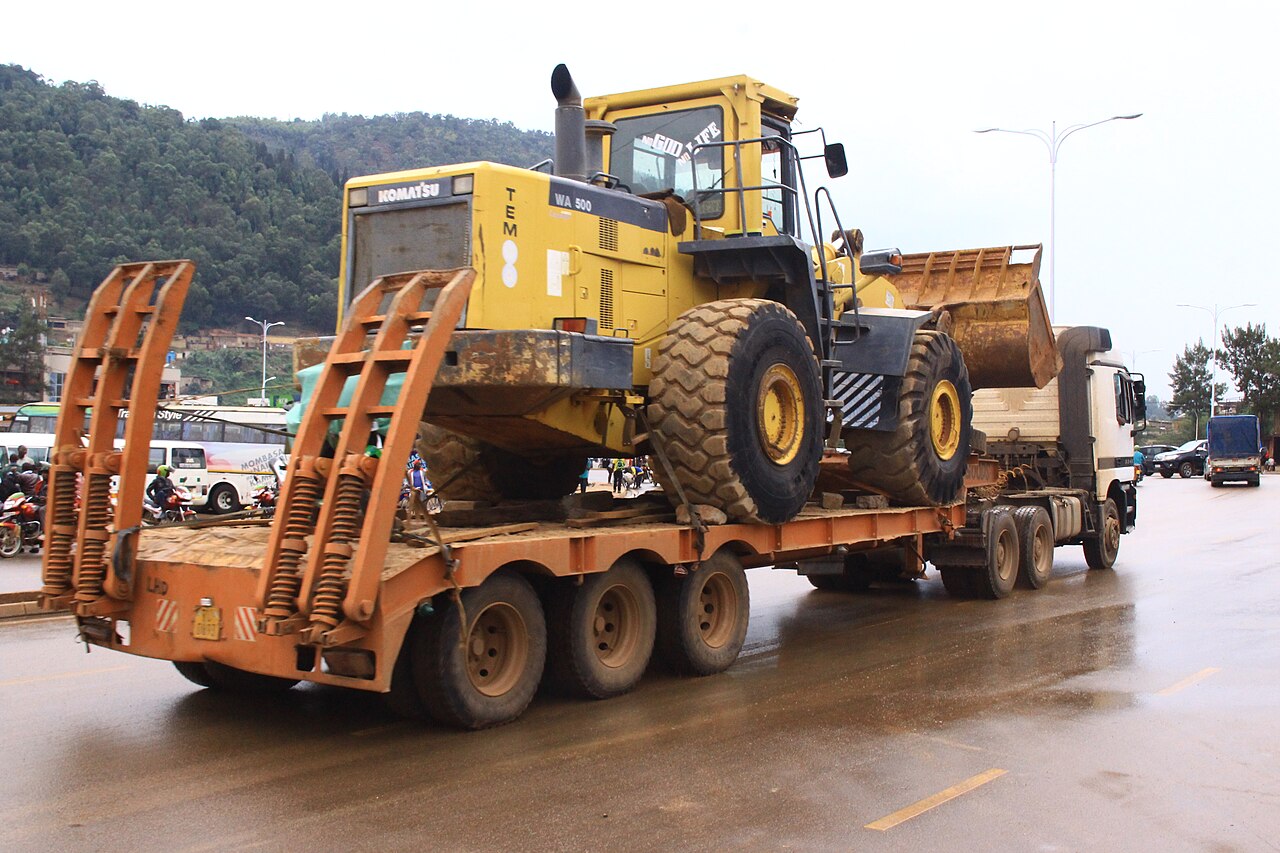Low-bed truck carrying heavy machinery in Kigali